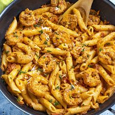 a skillet filled with pasta and meat covered in sauce