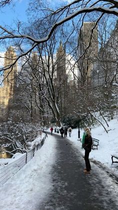 people walking in the snow along a path