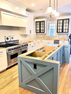 a kitchen with an island that has been built into the floor