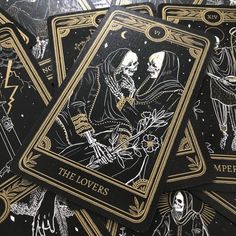 the lovers tarot cards are laying on top of each other, with skeleton illustrations