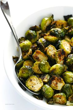 a white bowl filled with brussel sprouts on top of a table