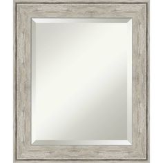 a silver framed mirror with an ornate design on the front and bottom edge, against a white background