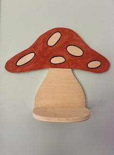 a wooden mushroom shaped object hanging on the wall