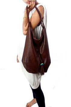 This large bohemian inspired leather tote is designed with simple lines. It is feminine and strong.  A hobo bag that has a generous amount of room for you to carry all your daily necessities and much more. It has one large exterior zipped pocket on the front of the bag and two inside. The outside zipper features a handmade leather tassel with a turquoise stone - this bag is a mix between boho elegance and everyday chic. The strap is hand braided leather. Handmade by me using extremely strong and Bohemian Leather Bag, Brand Purses, Bohemian Handbags, Brown Leather Tote Bag, Brown Leather Purse, Hobo Tote Bag, Cheap Purses, Purse Organizer, Brown Purse