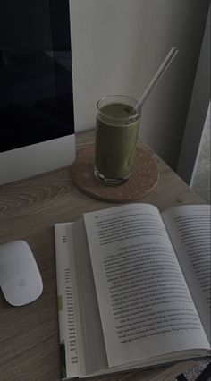 an open book sitting on top of a wooden table