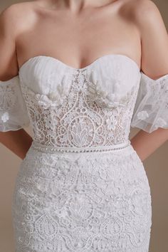 the back of a woman's white wedding dress