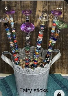 a bucket filled with lots of different colored glass beads