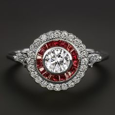 a diamond and ruby engagement ring on a black background