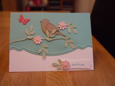 a card with a bird and flowers on it