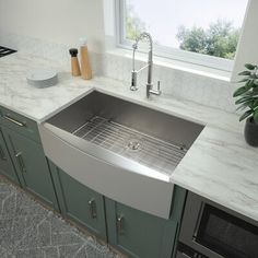 a black kitchen sink sitting under a window