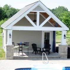 a pool house with a hot tub and patio furniture