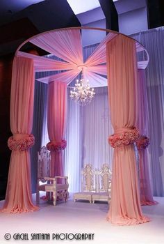 an elaborately decorated room with pink drapes and chandelier