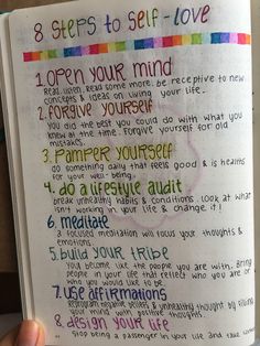 a hand holding an open notebook with the words 8 steps to self - love written on it