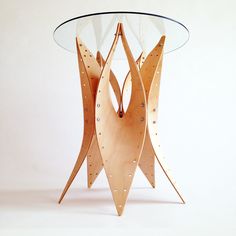 a wooden table with glass top and metal legs on the bottom, in front of a white background