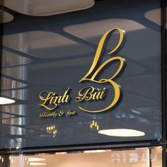 the logo for lind bui restaurant and bar is shown in gold on a glass window