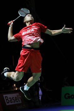 a man jumping in the air with a tennis racket