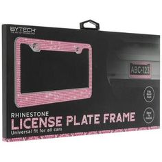 the license plate frame is pink and has diamonds on it, as well as an ad for