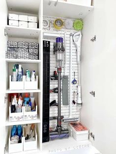 a white shelf filled with lots of crafting supplies and items on top of it