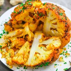 a white plate topped with cauliflower covered in seasoning