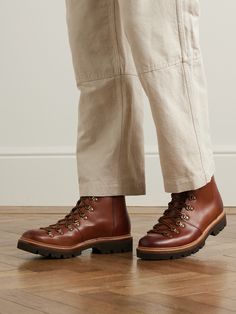 Grenson's 'Brady' hiking-style boots are designed with durability in mind, take the Goodyear-welted construction, D-ring lacing system and the lightweight rubber-lug soles that have excellent traction. Skip the rugged trails to keep the polished-leather uppers in good shape, wearing them with turned-up trousers instead. Large to size. See Size & Fit notes. This product was made from Considered Materials. Find out more about our Craftsmanship Code here. Rugged Goodyear Welted Lace-up Boots For Workwear, Abrasion-resistant Leather Hiking Work Boots, Leather Abrasion-resistant Hiking Boots, Barbour Boots, Rugged Abrasion-resistant Leather Hiking Boots, Grenson Shoes, Rugged Brown Work Boots Abrasion-resistant, Leather Hiking Boots, Black Shoes Men