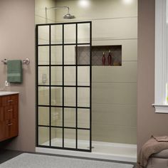 a bathroom with a glass shower door and sink