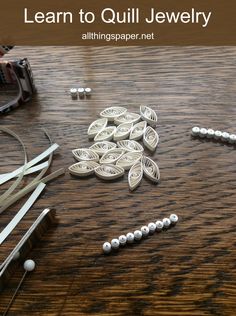 a wooden table topped with lots of crafting supplies on top of it's surface