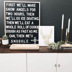 a wooden table topped with white cabinets and lots of candles next to a sign that reads, first we'll make snow angels for two hours then i'll go skating