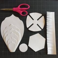 cut out paper shapes and scissors on a table