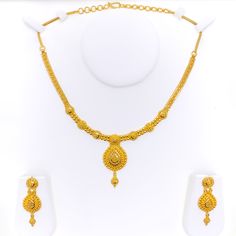 This 22k gold necklace set features an extravagant checkered drop design, radiating opulence and elegance. Weighing 30.0 grams, the set boasts a luminous yellow gold finish with a 16-inch necklace, adjustable by 1.75-inch links, and secured with a hook lock. The set includes matching earrings, each 1.75 inches long with screw-back posts for secure and comfortable wear. The intricate checkered pattern combined with the luxurious drop design makes this set perfect for those who appreciate bold and sophisticated jewelry, ideal for grand occasions and statement looks. PRODUCT DETAILS Gold Purity(karat): 22k Gold Weight(grams): 30.0 Item Finish: Yellow Gold Set Length: 16" Drop Length: 1.8" Adjustable Links: 1.75" Links Lock Style: Hook Lock Matching Earrings: Included Earring Length: 1.75" Ear Formal 22k Yellow Gold Kundan Necklace, Formal Yellow 22k Gold Jewelry, Formal Yellow 22k Gold Chain Necklace, Yellow Necklace For Formal Festive Occasions, Yellow Necklace For Festive Formal Occasions, Yellow Formal Necklace For Festive Occasions, Festive Yellow Necklace For Formal Occasions, Yellow Festive Formal Necklace, 22k Gold Necklace Set