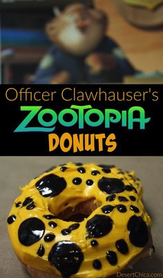 a close up of a doughnut with yellow frosting and black dots on it