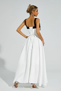 The Camp White Bow Tie Slip Dress exudes an elegant and sophisticated charm. Crafted with utmost care, this dress is perfect for special occasions. Its unique design features beautiful bows tie and delicate straps. With a touch of French chic, this dress embodies the essence of a refined and graceful woman. Ideal for formal events, birthdays, or as a hostess outfit, this dress will elevate your look with its undeniable luxury and finesse.  Dress Length: Approx 150cm Materials: Polyester Gentle D Elegant A-line Dresses With Bow Straps, White A-line Dress With Bow Straps, Elegant Evening Corset Dress With Bow, Sleeveless Corset Dress With Bow Straps For Party, Elegant Fitted Corset Dress With Bow Straps, White Bow Tie Back Evening Dress, White Evening Dress With Bow Tie Back, Party Corset Dress With Tie Straps And Fitted Bodice, Elegant Dress With Bow And Sweetheart Neckline