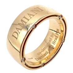 a gold wedding ring with diamonds on the outside and inside, inlaided with words