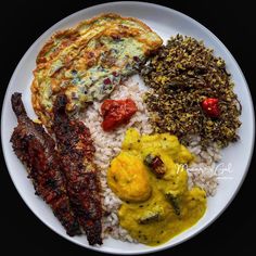 a white plate topped with different types of food on top of rice and sauces