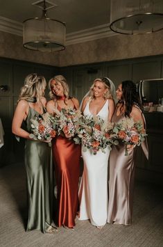 the bridesmaids are holding their bouquets and posing for a photo in the room