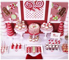 a table topped with lots of cakes and cupcakes