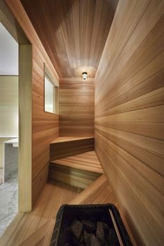 an empty sauna room with wooden walls and flooring is shown in this image