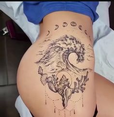 a woman's stomach with tattoos on it and an ocean wave in the middle