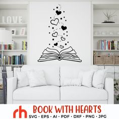 an open book with hearts flying out of it in front of a wall decal