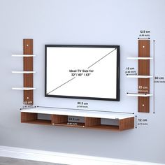 a flat screen tv mounted to the side of a wall with shelving underneath it