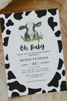 a black and white cow baby shower is shown