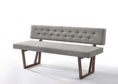 a gray bench sitting on top of a white floor