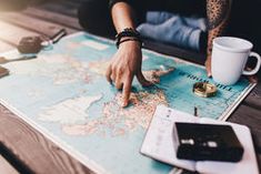 a person pointing at a map on a table