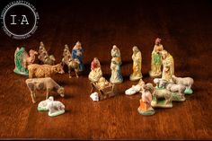 a group of figurines sitting on top of a wooden table