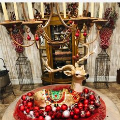 a deer statue sitting on top of a table covered in ornaments