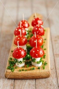 small appetizers with tomatoes and parsley on a wooden board, ready to be eaten