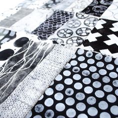 the black and white quilt is made up of many different types of fabric patterns on it