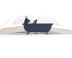 an open book with a black cat in a bathtub