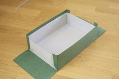 an open box sitting on top of a wooden floor