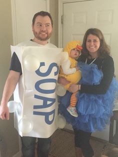 a man and woman holding a baby in a bag that says'best family halloween costumes - cute ideal family fun '