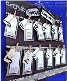 a birthday card hanging on a clothes line with name tags attached to the pegs